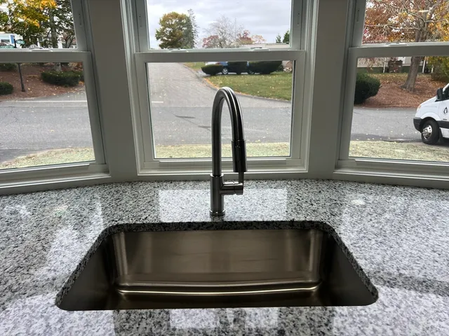 a kitchen with granite countertop a sink and a window