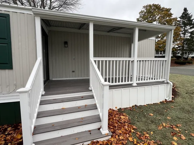 a view of a house with a wooden fence