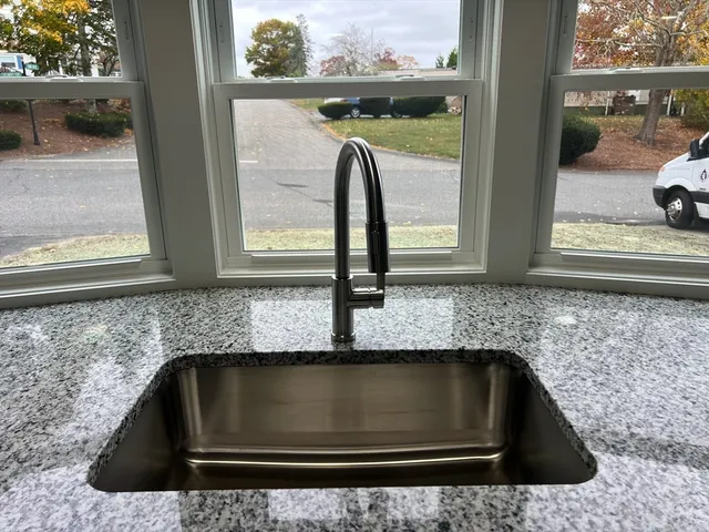 a kitchen with granite countertop a sink and a window