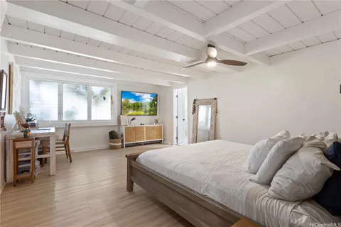 a bedroom with a bed furniture and wooden floor