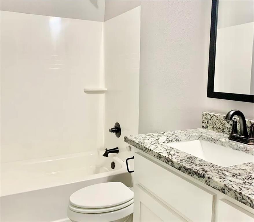 312 North Elliott Avenue Sherman, TX 75092 - Photo 10 of 10 a bathroom with a granite countertop sink toilet and shower