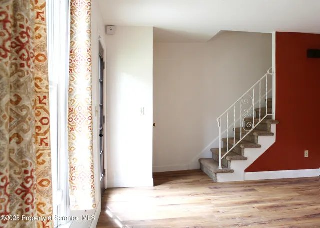 a view of entryway with wooden floor
