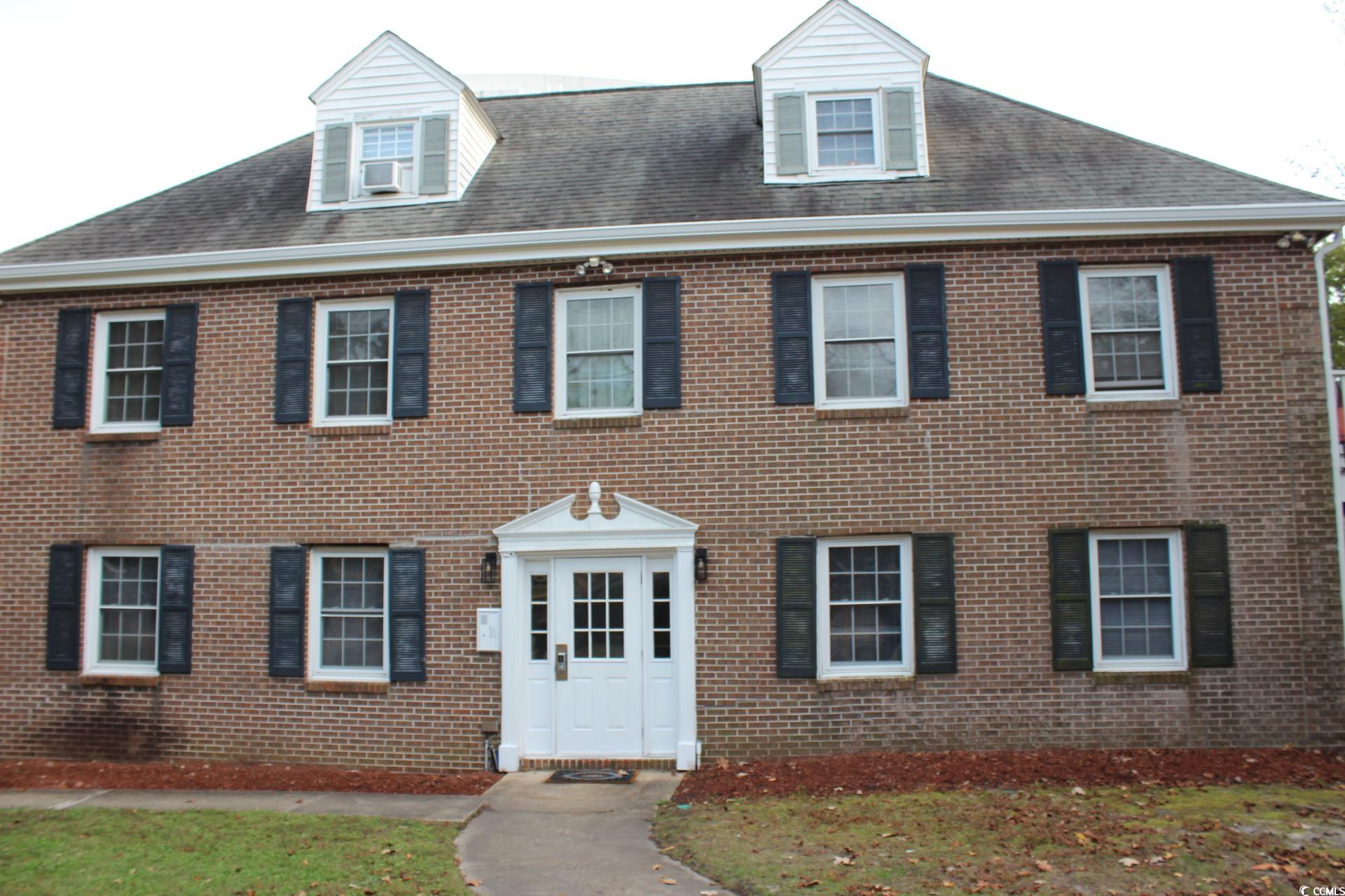 1500 Chester Street, Unit 2 Myrtle Beach, SC 29577 - Photo 1 of 9 Colonial home with brick siding and a shingled roof