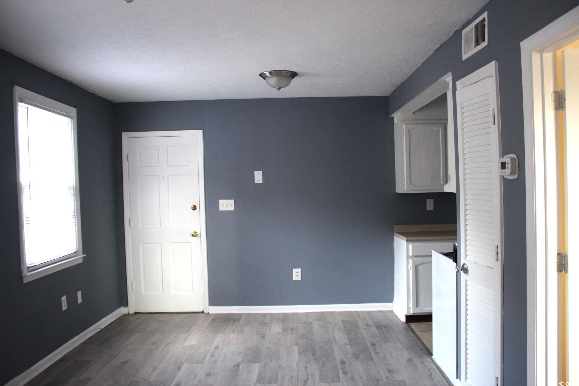 1500 Chester Street, Unit 2 Myrtle Beach, SC 29577 - Photo 3 of 9 Kitchen with dark wood-type flooring, white cabinets, and dark countertops