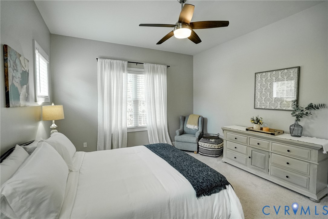4669 Woburn Road Providence Forge, VA 23140 - Photo 27 of 78 a bedroom with a bed and a chandelier
