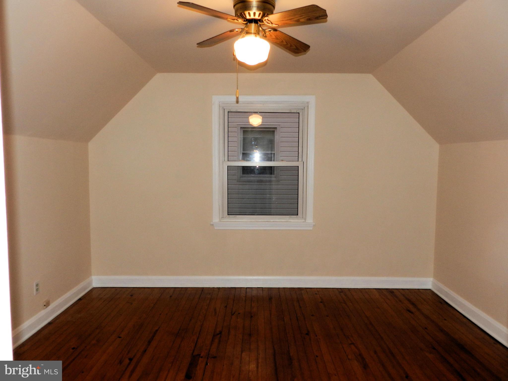 1502 Rita Road Dundalk, MD 21222 - Photo 14 of 21 wooden floor in an empty room with a window