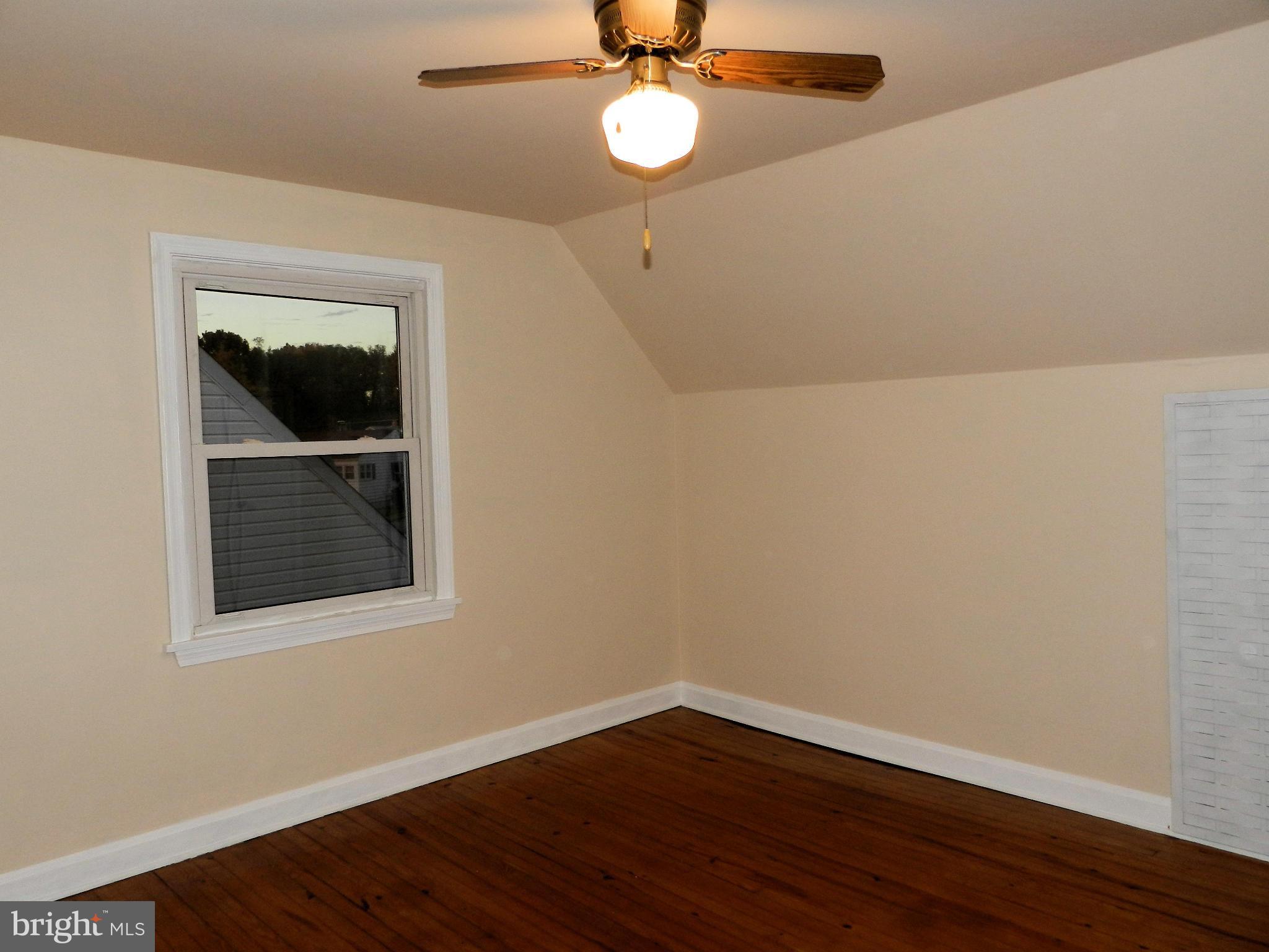 1502 Rita Road Dundalk, MD 21222 - Photo 16 of 21 a view of a room with wooden floor and fan
