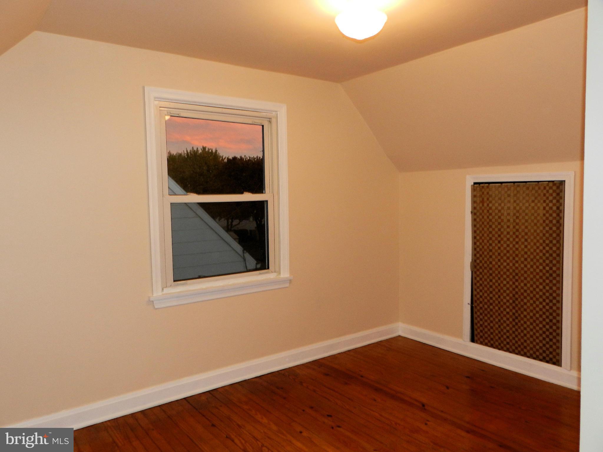 1502 Rita Road Dundalk, MD 21222 - Photo 17 of 21 a view of an empty room with wooden floor and a window