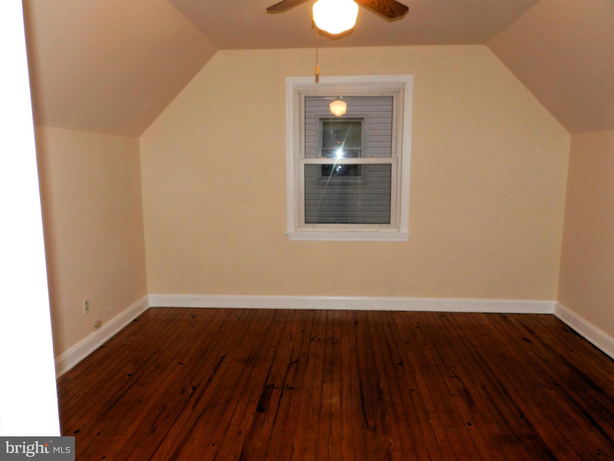 1502 Rita Road Dundalk, MD 21222 - Photo 19 of 21 an empty room with wooden floor and windows