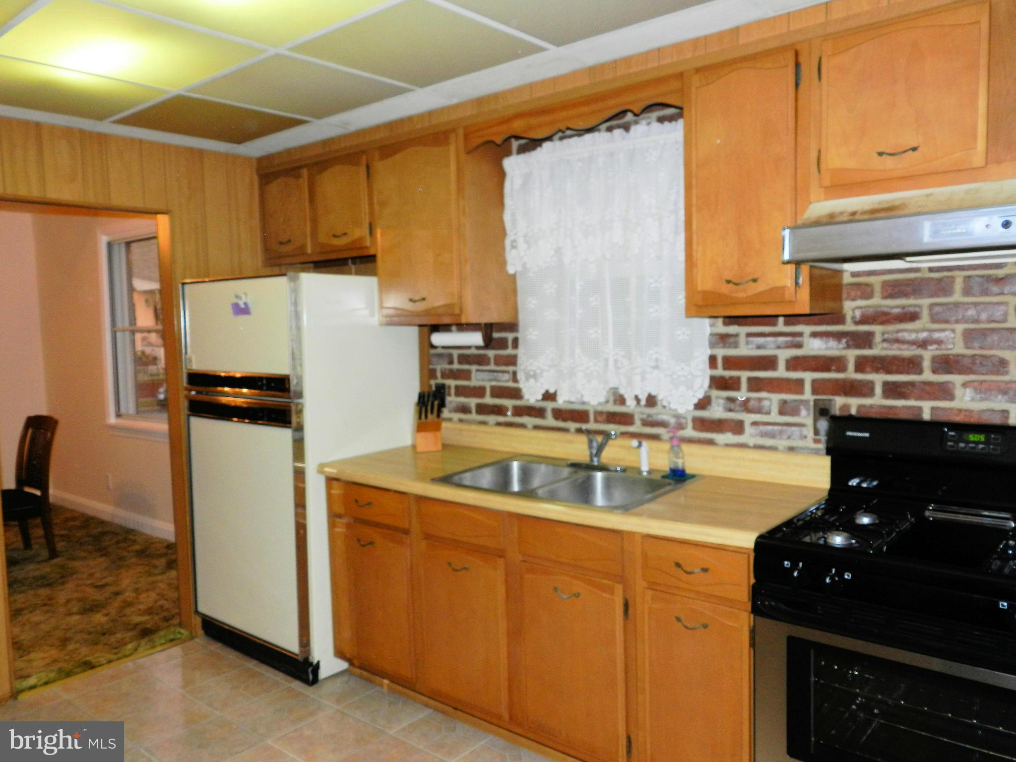 1502 Rita Road Dundalk, MD 21222 - Photo 3 of 21 a kitchen with a refrigerator and a sink
