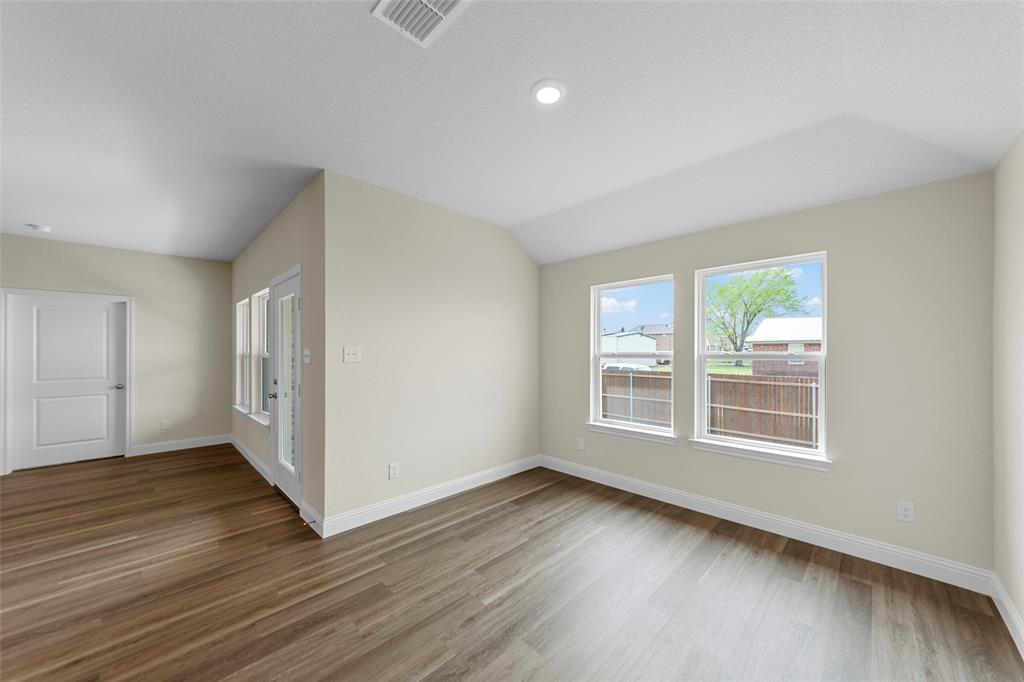 210 Pennington Road Josephine, TX 75173 - Photo 6 of 23 an empty room with wooden floor and windows