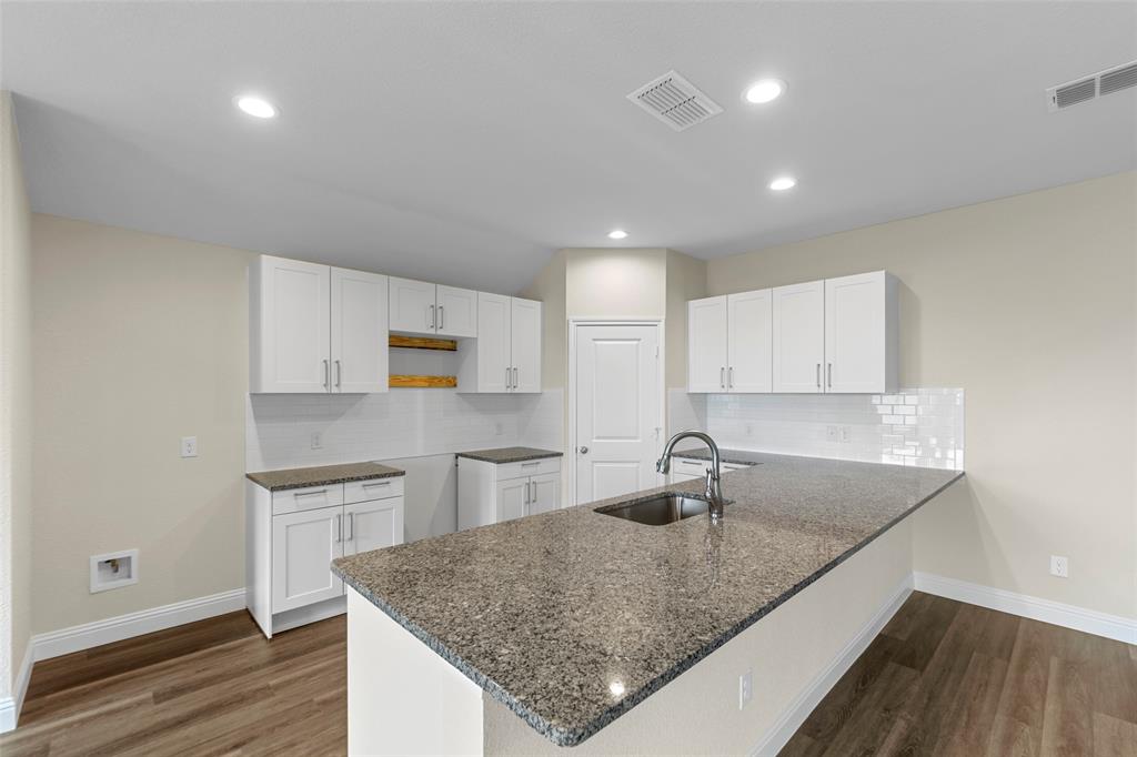 210 Pennington Road Josephine, TX 75173 - Photo 9 of 23 a kitchen with stainless steel appliances granite countertop a sink stove and cabinets