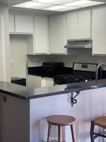 a kitchen with a cabinets and chairs