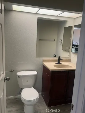 a bathroom with a sink toilet and mirror