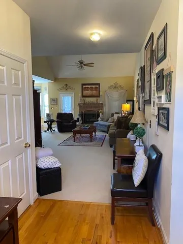 a living room with furniture and wooden floor