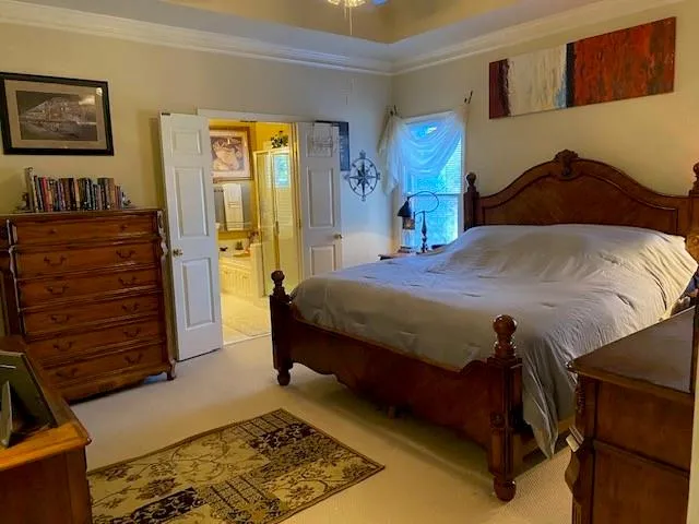 a bedroom with a bed and a dresser in it