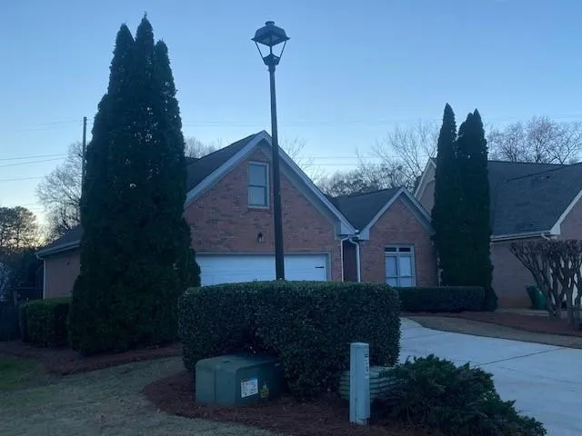 a front view of a house with a garden