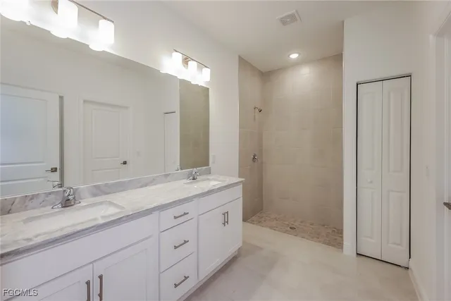a bathroom with a granite countertop sink mirror and double
