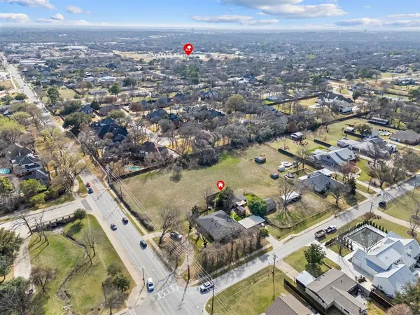 an aerial view of residential houses with outdoor space