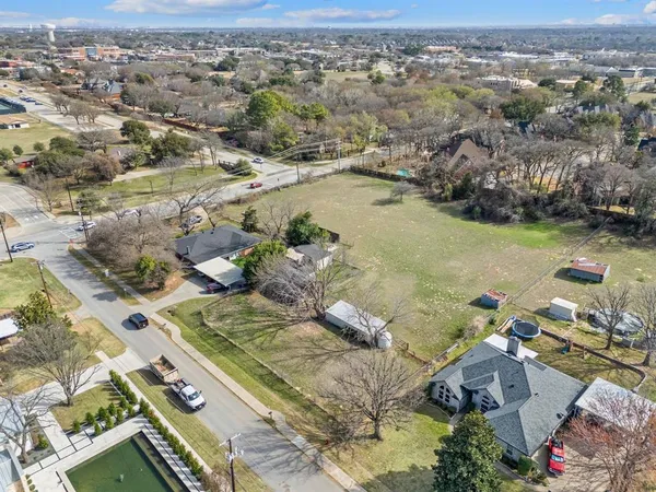 an aerial view of a residential houses with outdoor space