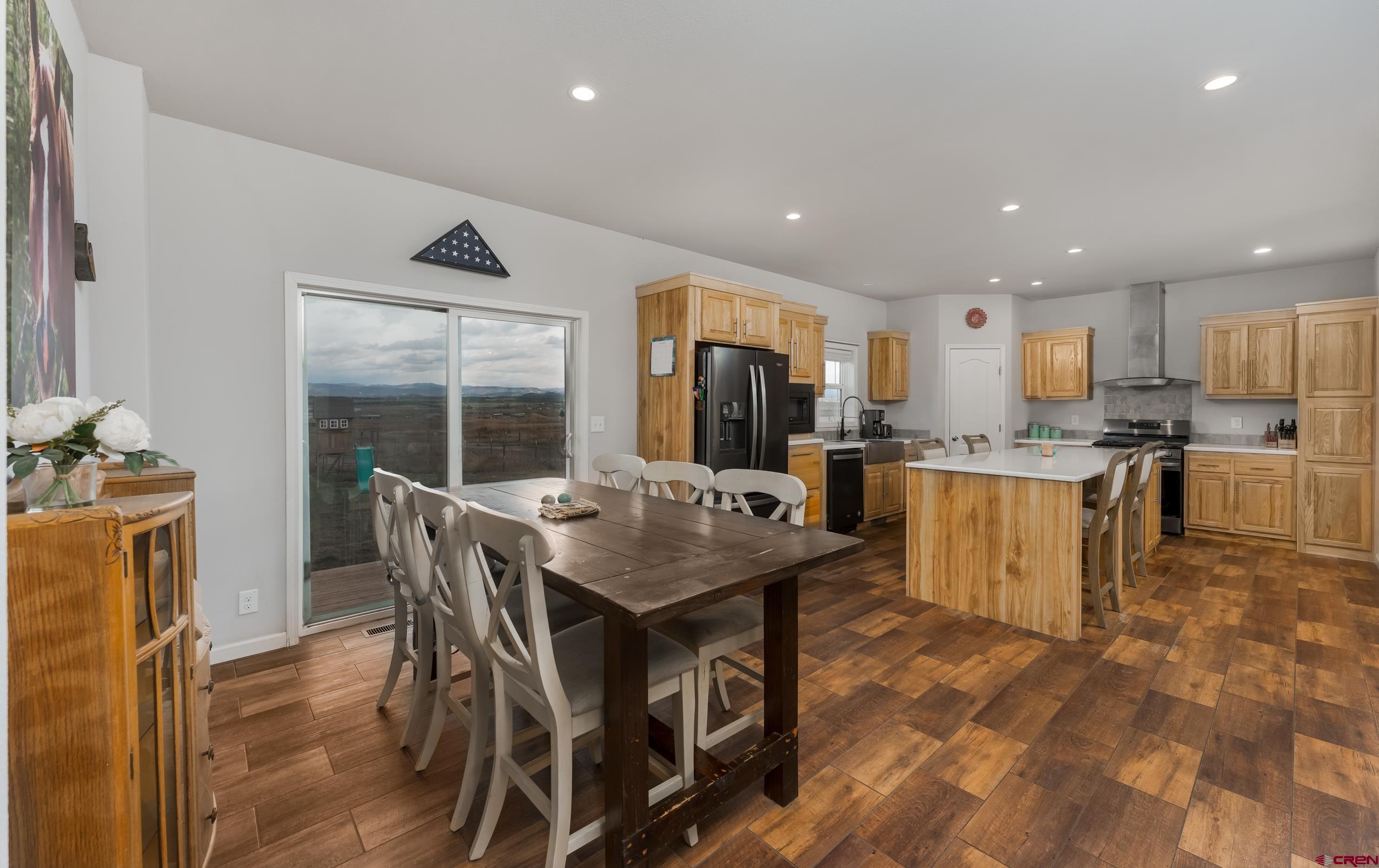 270 Rock Ranch Ignacio, CO 81137 - Photo 13 of 35 a open dining room with stainless steel appliances kitchen island granite countertop a table chairs and a refrigerator