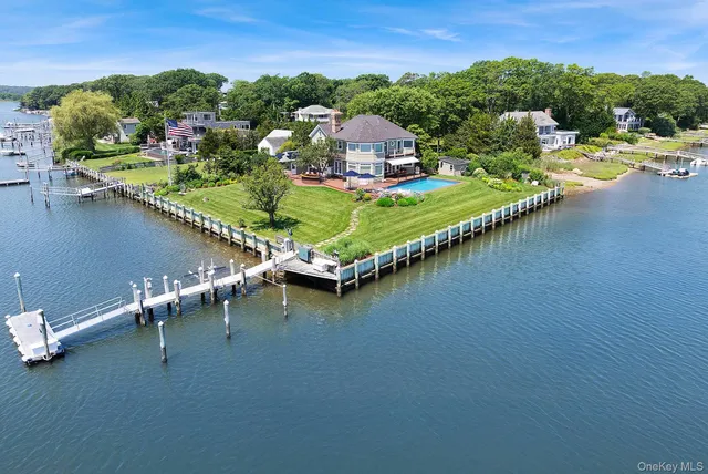 an aerial view of a house with swimming pool and lake view