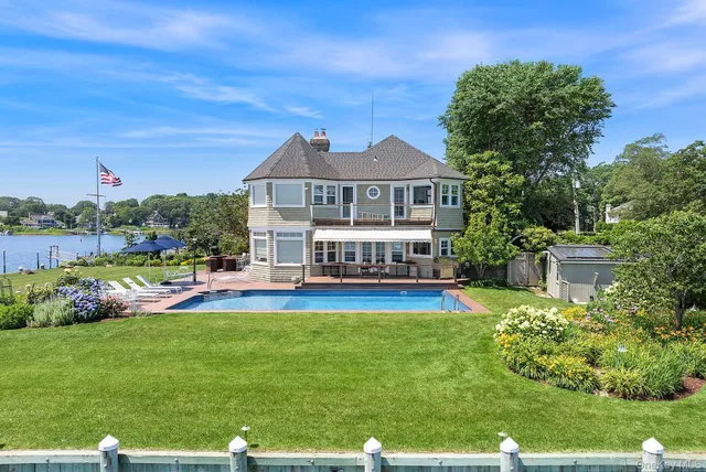 a view of a house with a yard patio and swimming pool