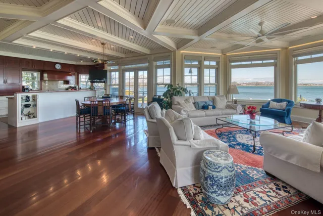 a living room with furniture wooden floor and a large window