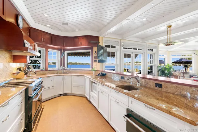 a kitchen with a sink a counter top space and stainless steel appliances
