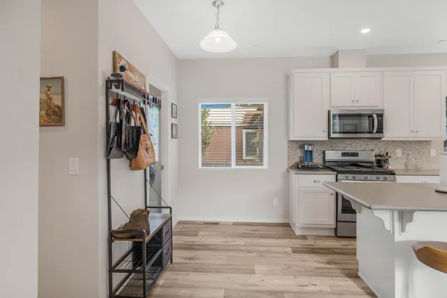 a kitchen with stainless steel appliances a stove refrigerator sink and microwave