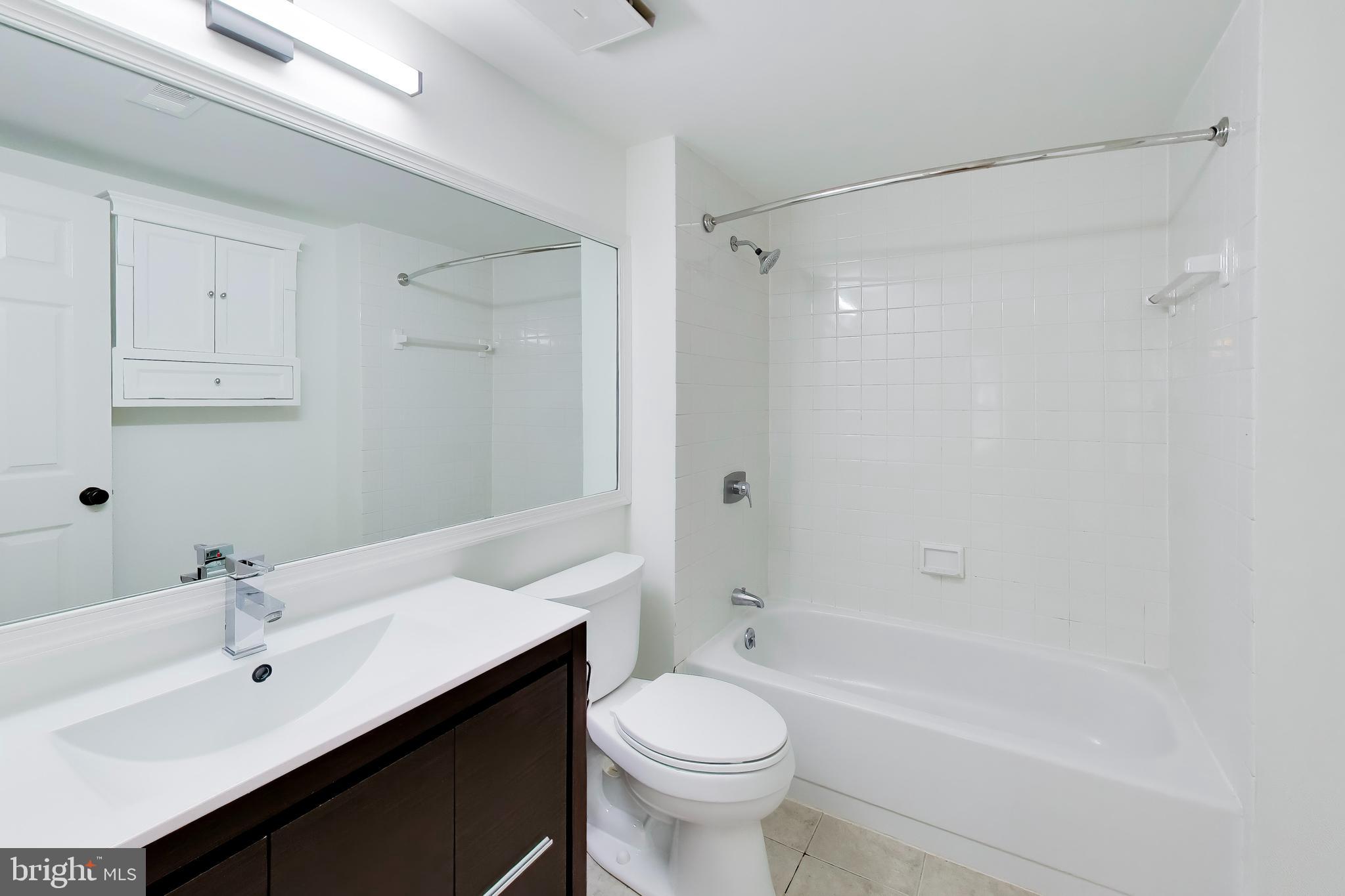 1730 16th Street Northwest, Unit 14 Washington, DC 20009 - Photo 11 of 17 a bathroom with a sink toilet and shower