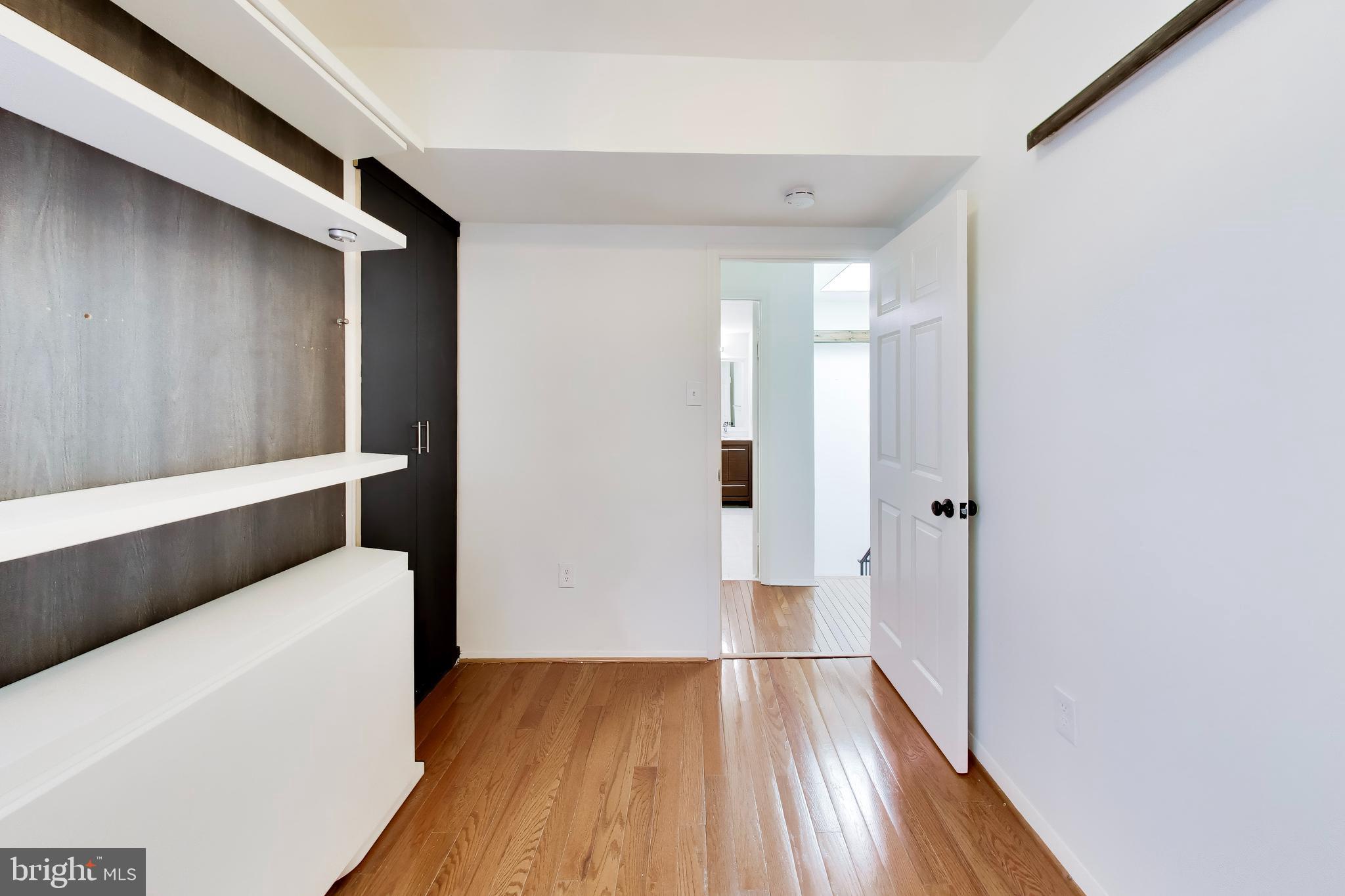 1730 16th Street Northwest, Unit 14 Washington, DC 20009 - Photo 13 of 17 a view of walk in closet with wooden floor