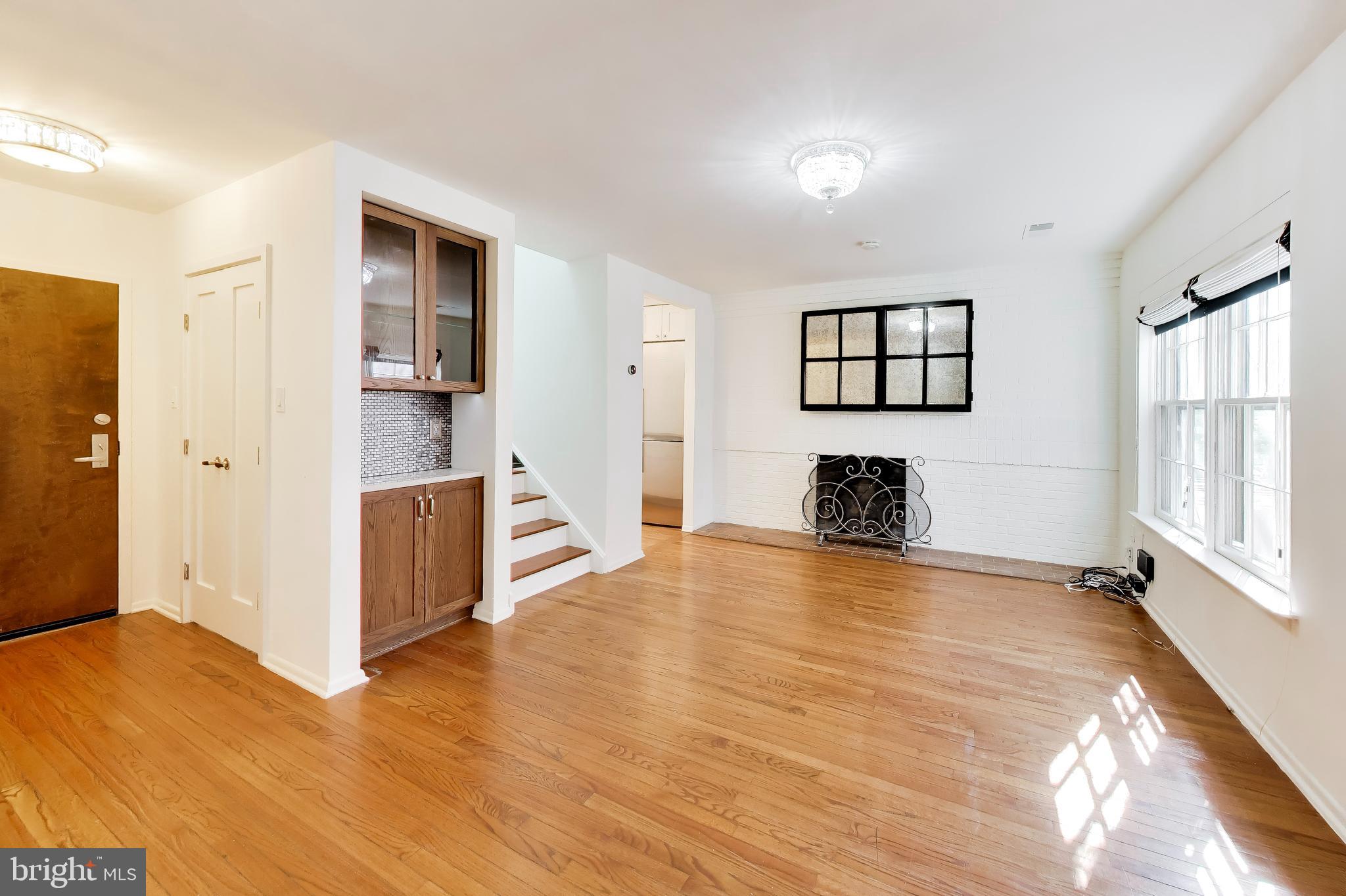 1730 16th Street Northwest, Unit 14 Washington, DC 20009 - Photo 3 of 17 a view of a livingroom with wooden floor and a cabinet