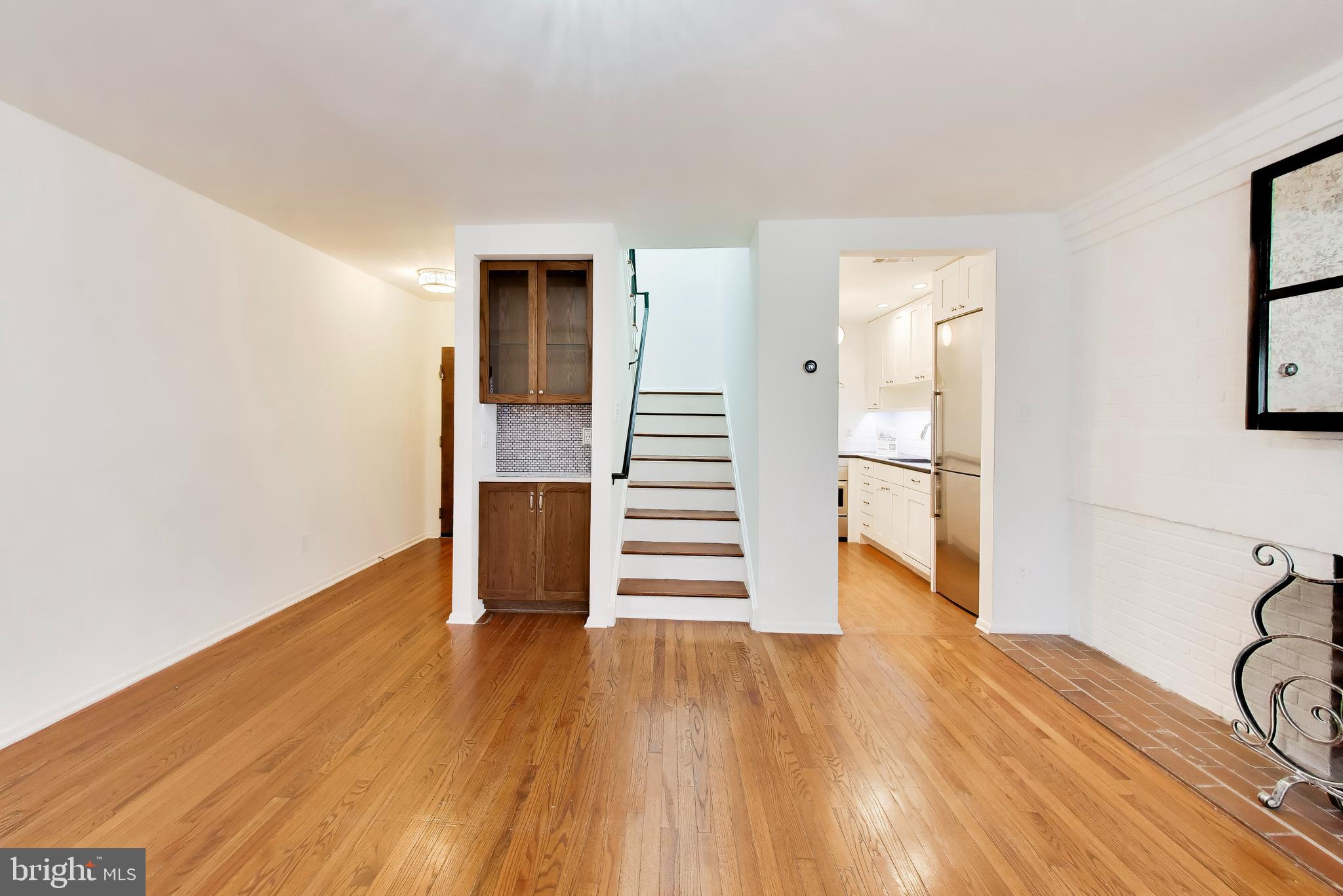 1730 16th Street Northwest, Unit 14 Washington, DC 20009 - Photo 4 of 17 a view of a room with wooden floor and stairs