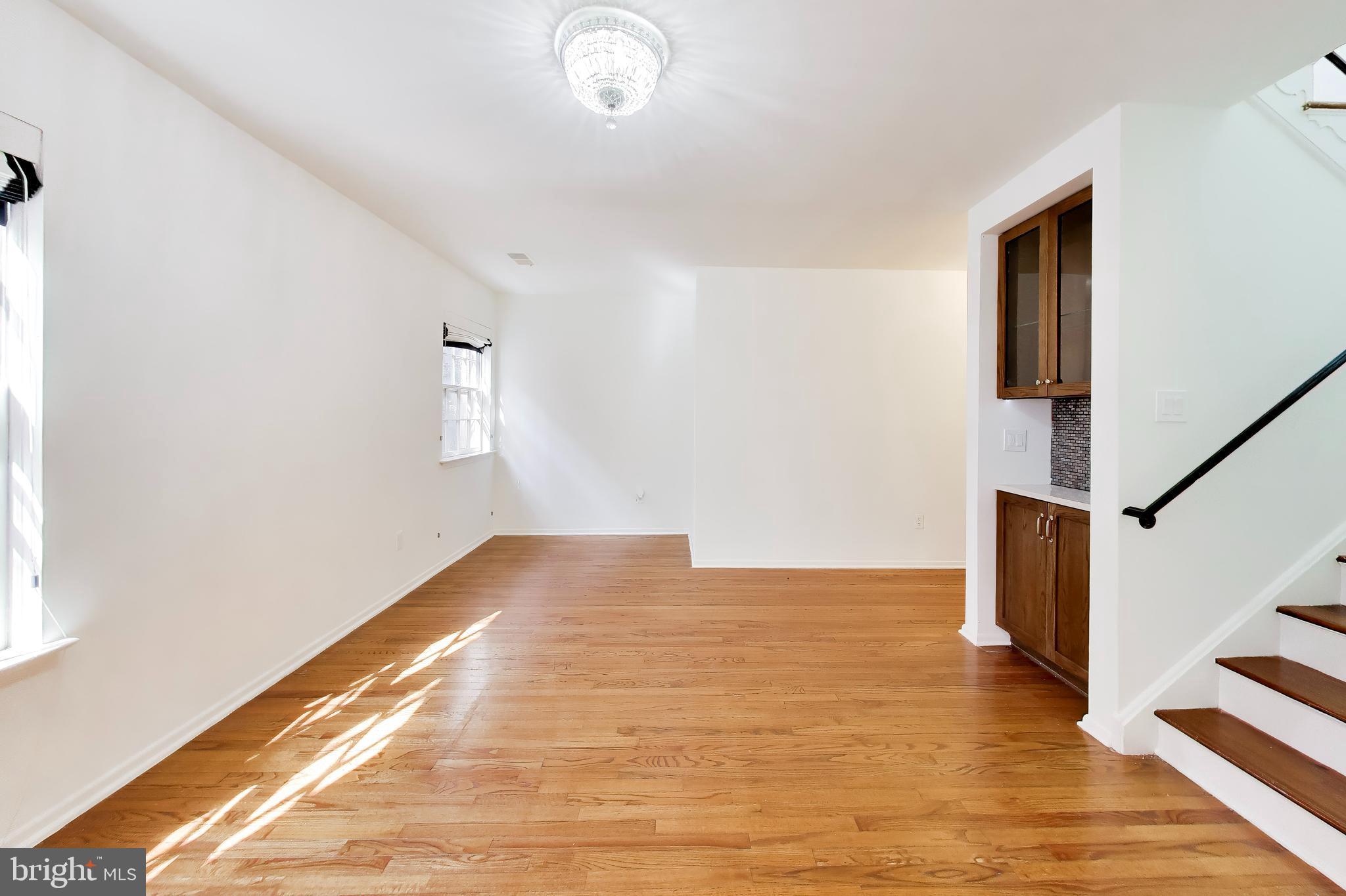 1730 16th Street Northwest, Unit 14 Washington, DC 20009 - Photo 5 of 17 a view of an empty room with wooden floor and a window