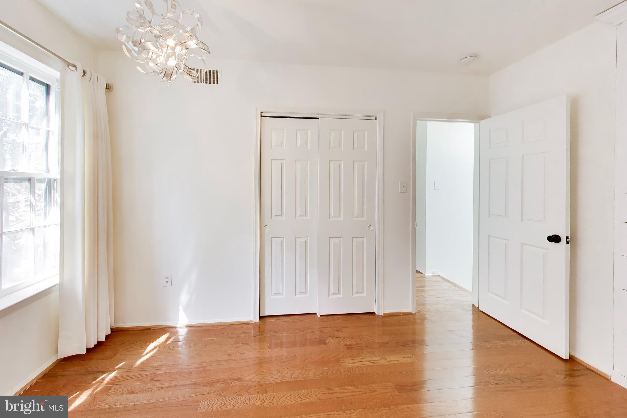 1730 16th Street Northwest, Unit 14 Washington, DC 20009 - Photo 10 of 17 a view of an empty room with window and wooden floor