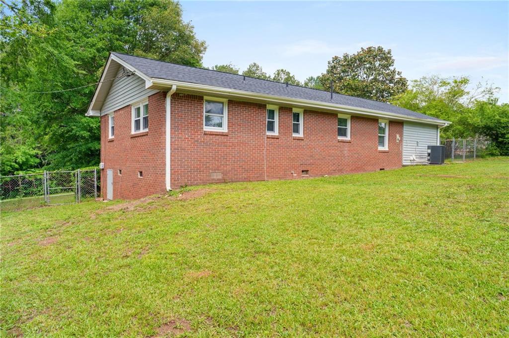 1745 Rockbridge Road Northwest Conyers, GA 30012 - Photo 25 of 32 a front view of a house with garden
