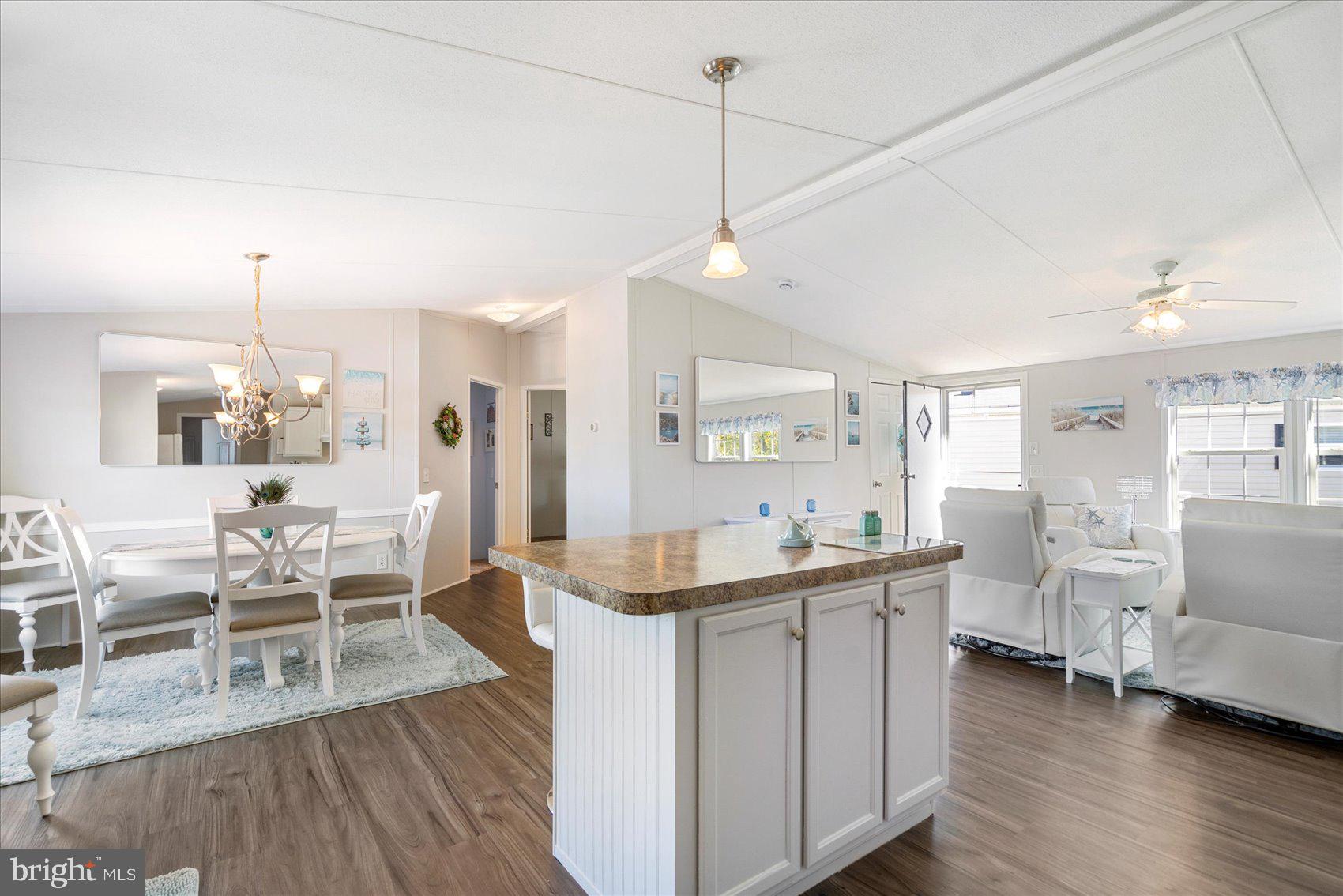 28 Shore Road Sparrows Point, MD 21219 - Photo 12 of 20 a view of a dining room and livingroom with furniture wooden floor a chandelier