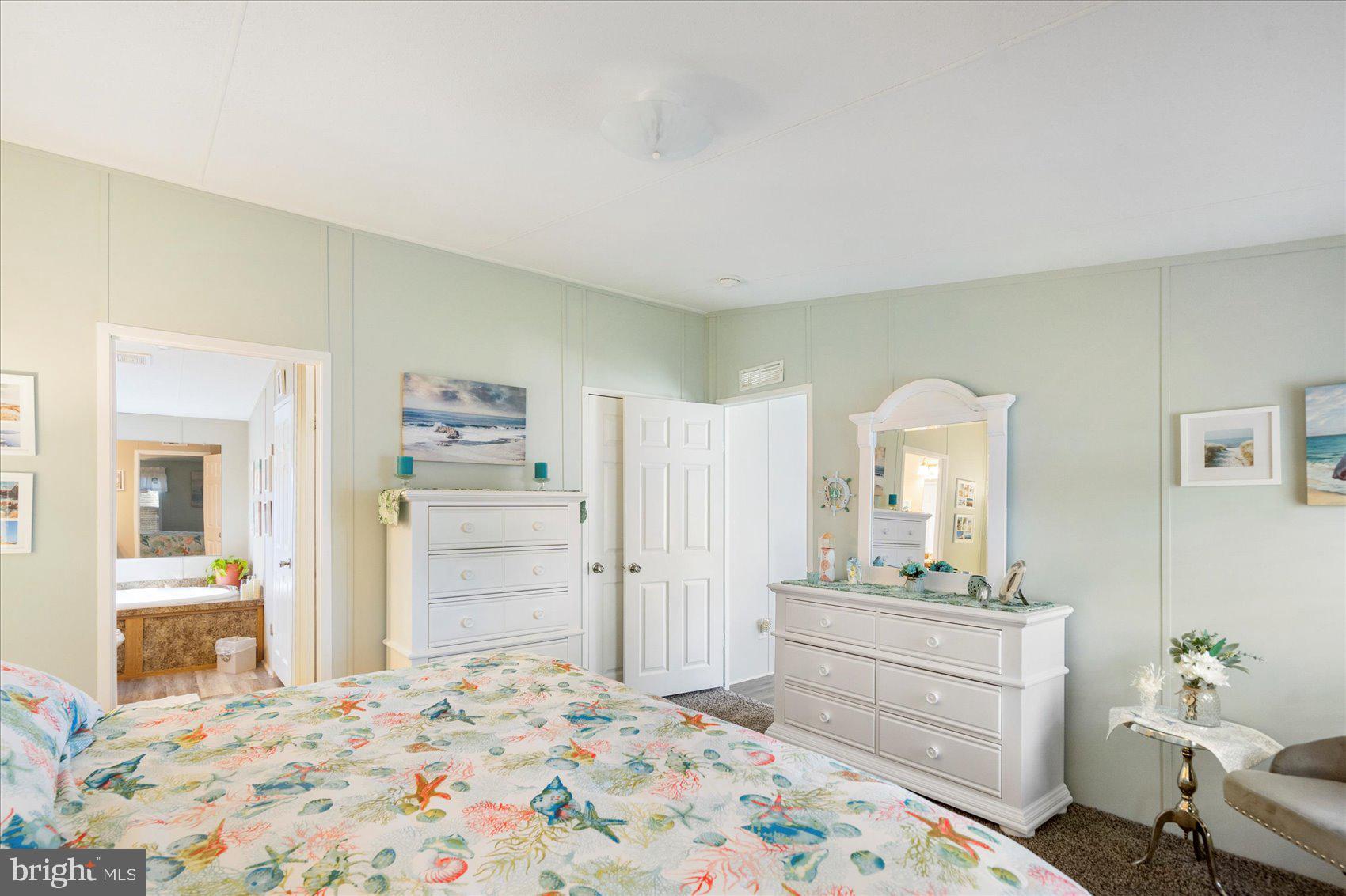 28 Shore Road Sparrows Point, MD 21219 - Photo 14 of 20 a bedroom with a bed and a dresser in it