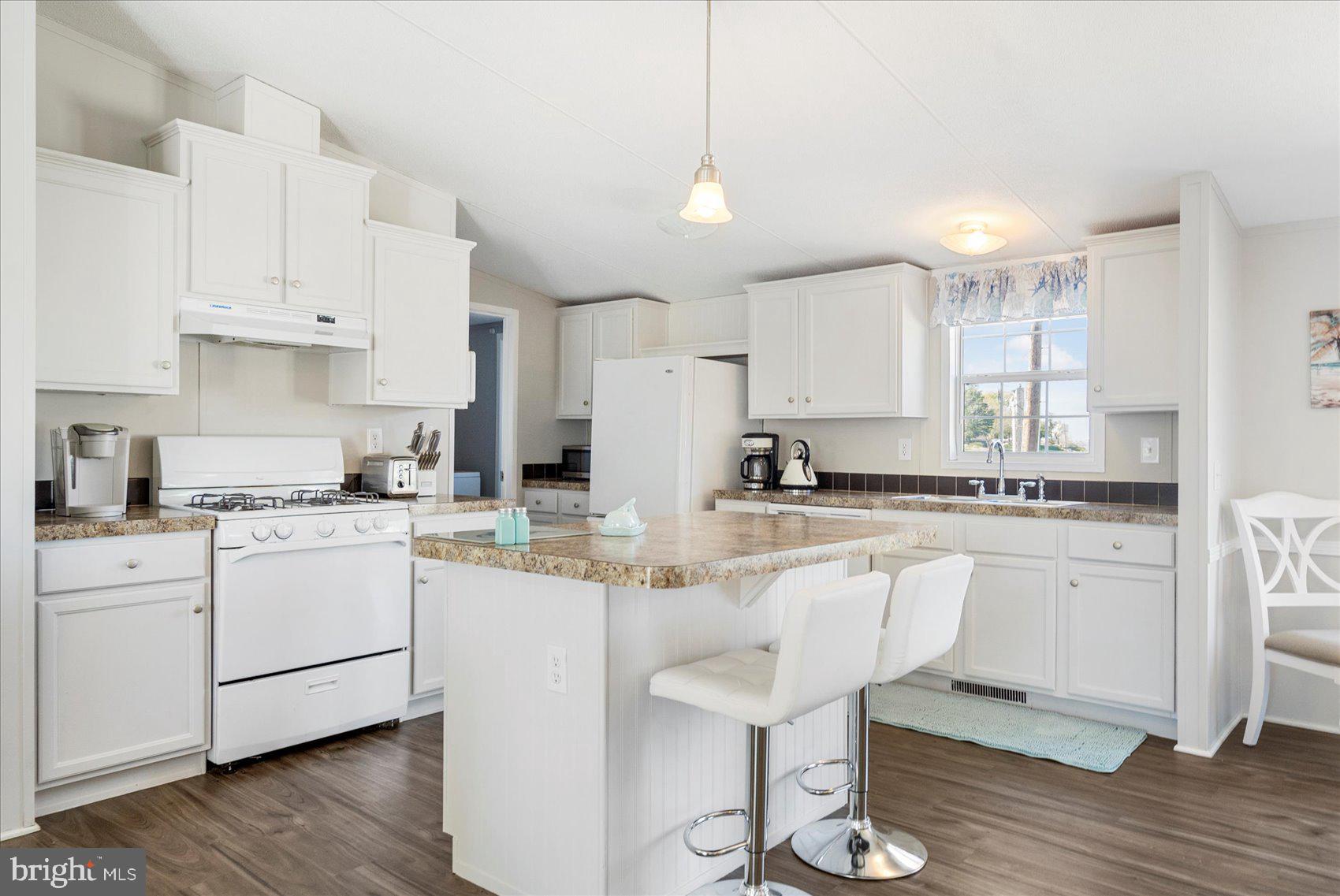 28 Shore Road Sparrows Point, MD 21219 - Photo 2 of 20 a kitchen with white cabinets and sink