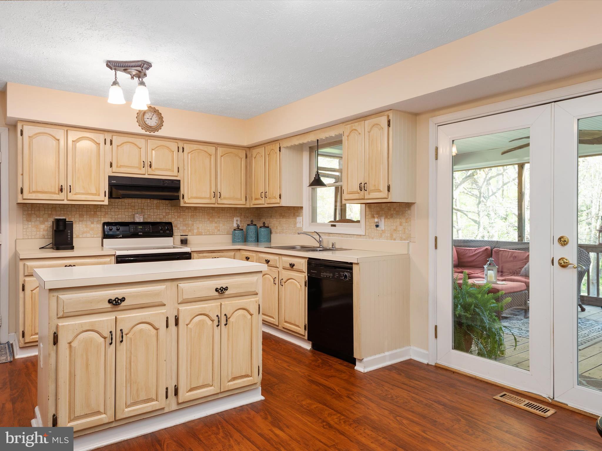 276 Greenridge Drive Dunkirk, MD 20754 - Photo 14 of 49 a kitchen with granite countertop a stove a sink dishwasher and a refrigerator with wooden floor