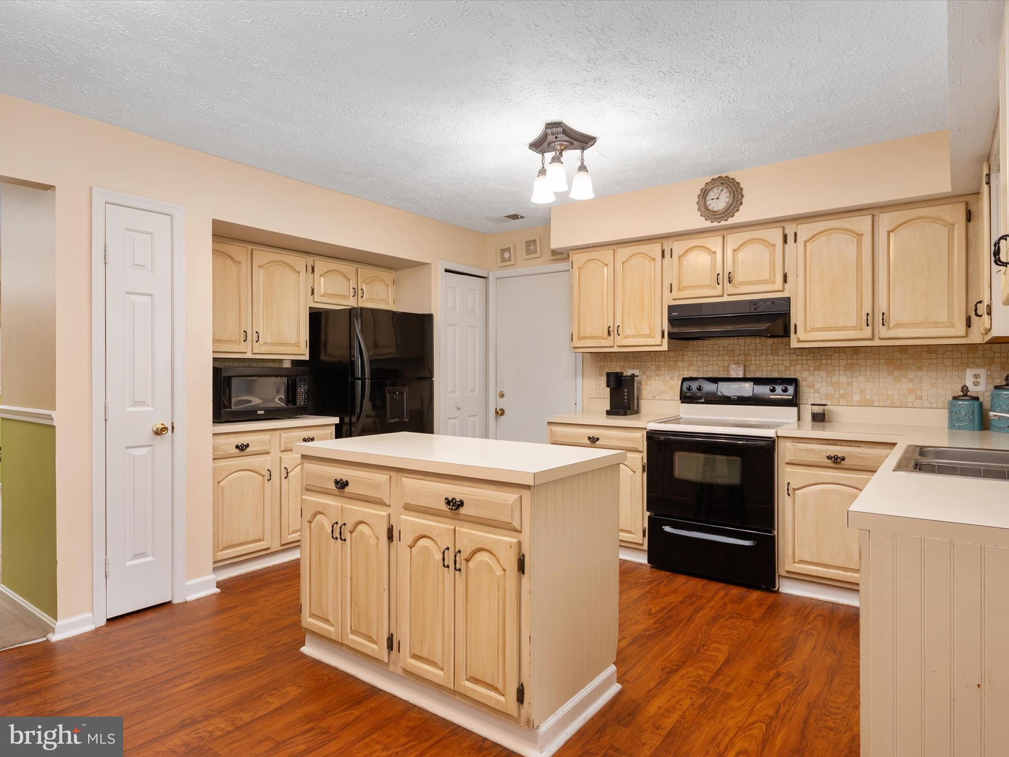 276 Greenridge Drive Dunkirk, MD 20754 - Photo 15 of 49 a kitchen with kitchen island granite countertop a sink stainless steel appliances and cabinets