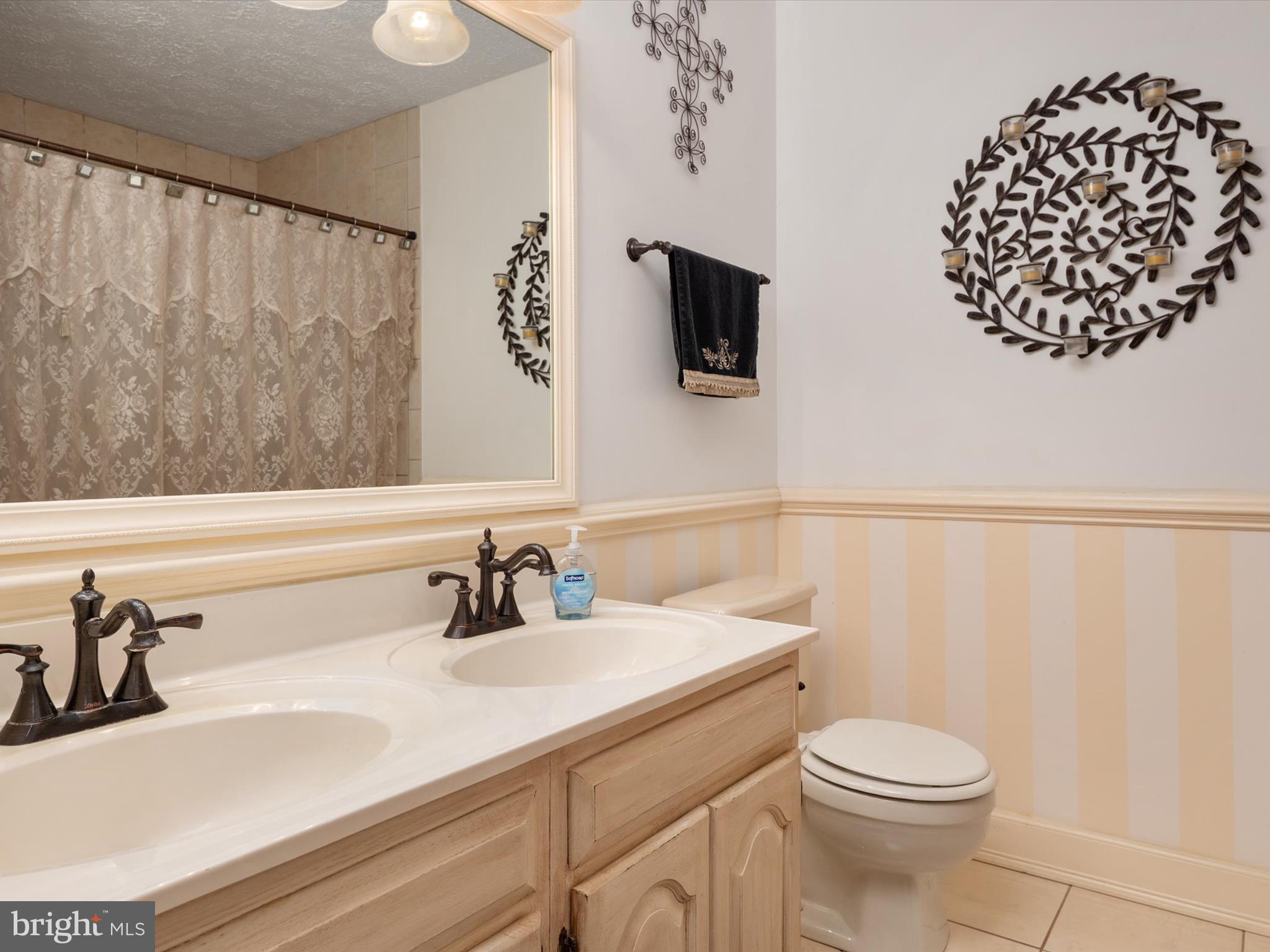 276 Greenridge Drive Dunkirk, MD 20754 - Photo 24 of 49 a bathroom with a sink a toilet and a mirror