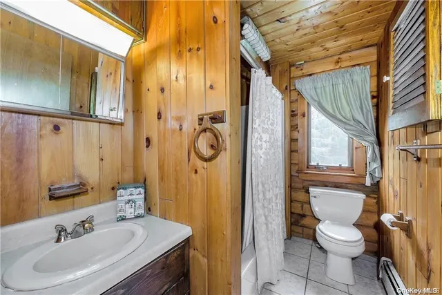 a bathroom with a sink a toilet a mirror and shower