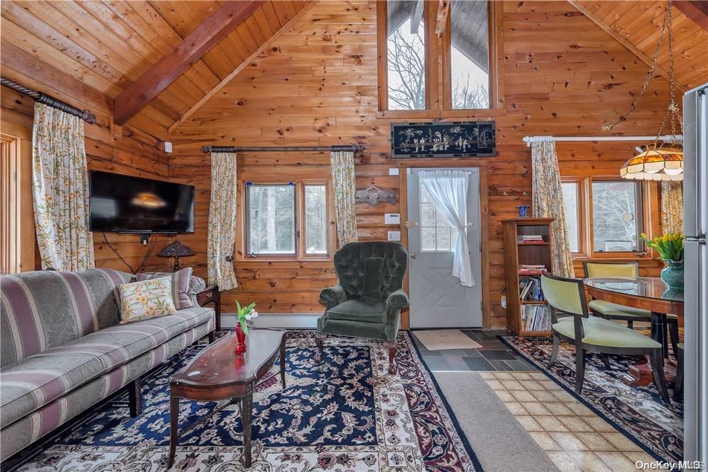 835 Ulster Heights Road Wawarsing, NY 12428 - Photo 3 of 24 a living room with furniture and a flat screen tv