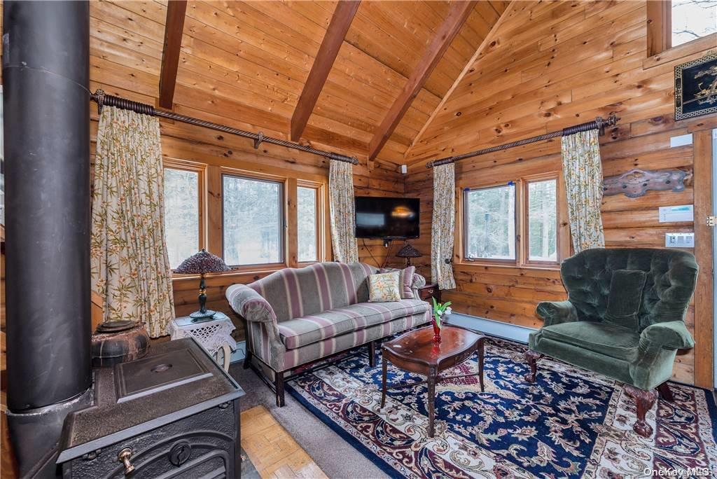 835 Ulster Heights Road Wawarsing, NY 12428 - Photo 4 of 24 a living room with furniture or couch and a large window