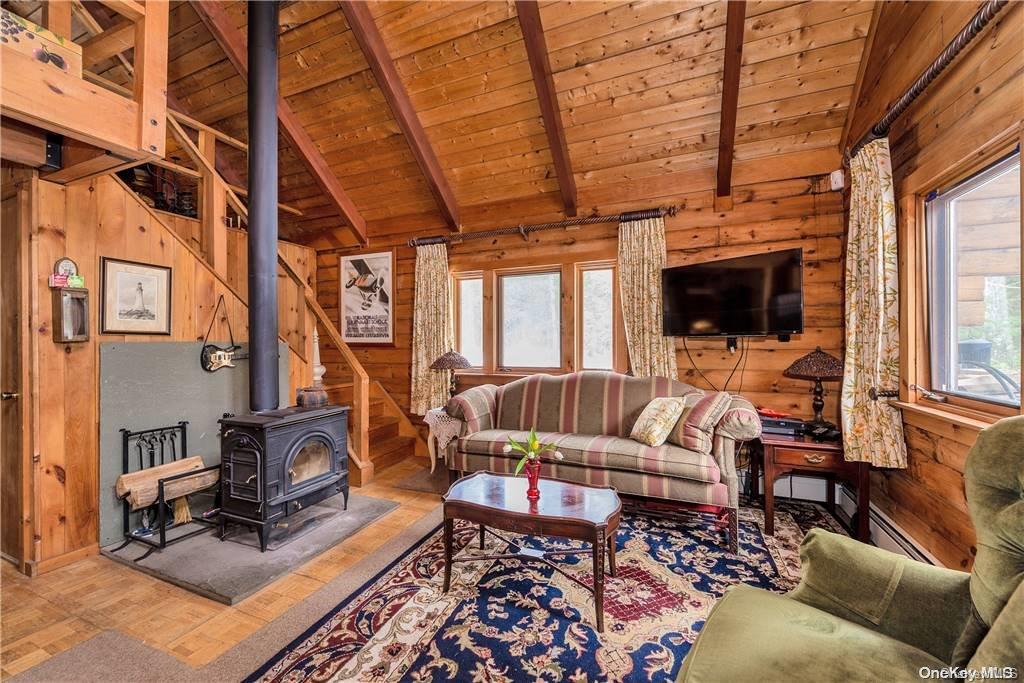 835 Ulster Heights Road Wawarsing, NY 12428 - Photo 6 of 24 a living room with furniture or outdoor view and a fireplace