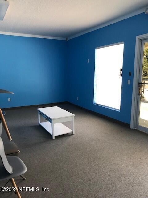 387 New Berlin Road, Unit 1 Jacksonville, FL 32218 - Photo 3 of 4 a view of a room with gym equipment and a window