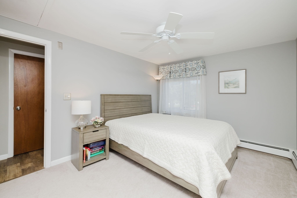 43 Will Drive, Unit 30 Canton, MA 02021 - Photo 13 of 25 a bedroom with a bed and a chandelier