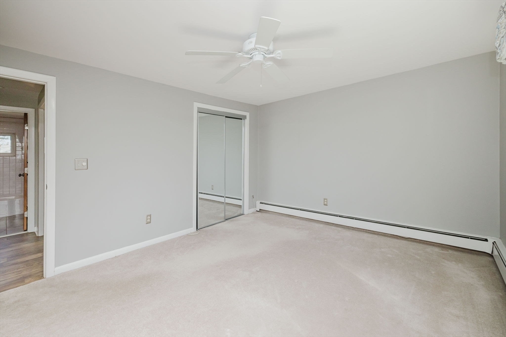 43 Will Drive, Unit 30 Canton, MA 02021 - Photo 16 of 25 an empty room with a ceiling fan and closet area